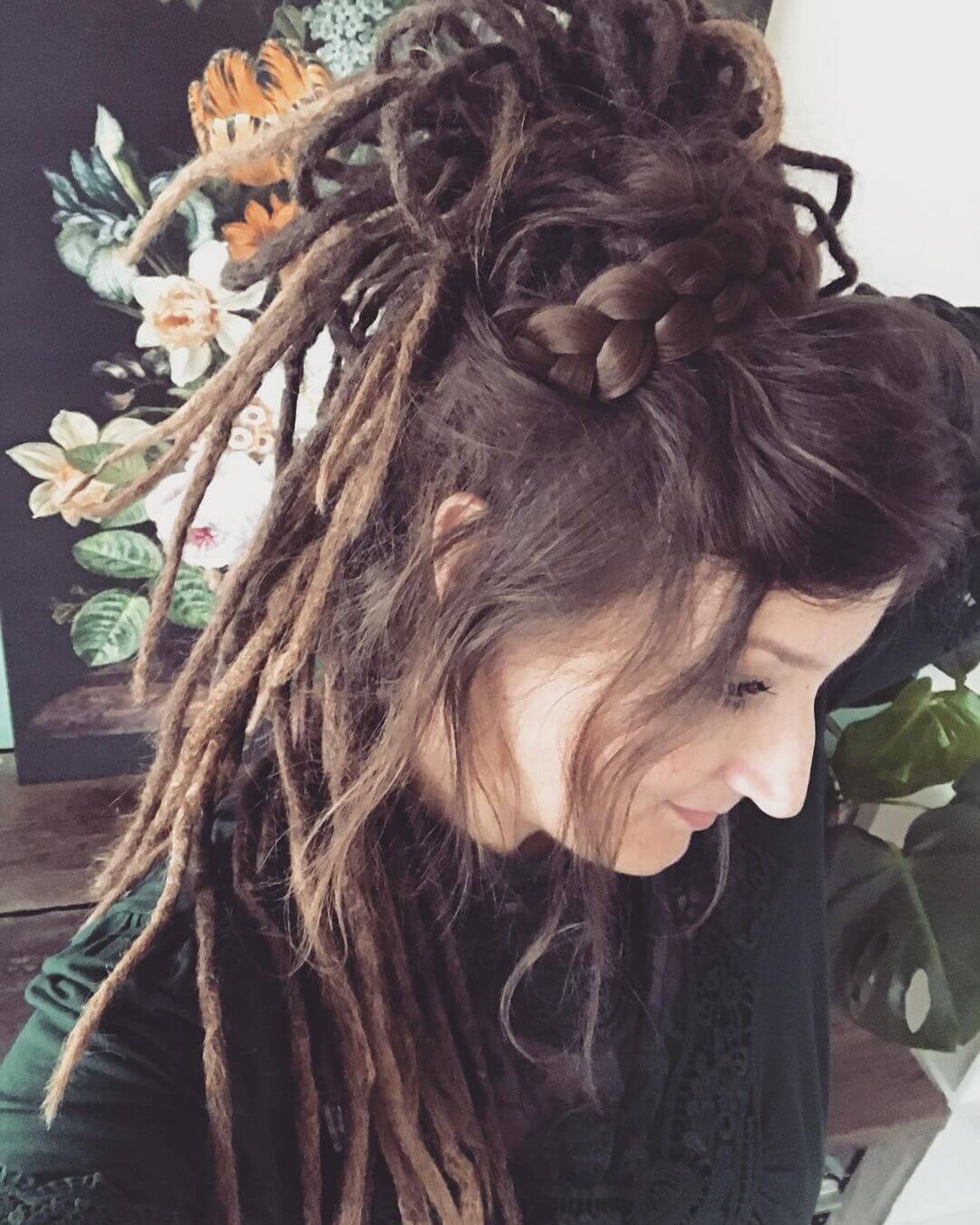 Elegant updo combining a braided crown and a bun made entirely of dreadlocks.