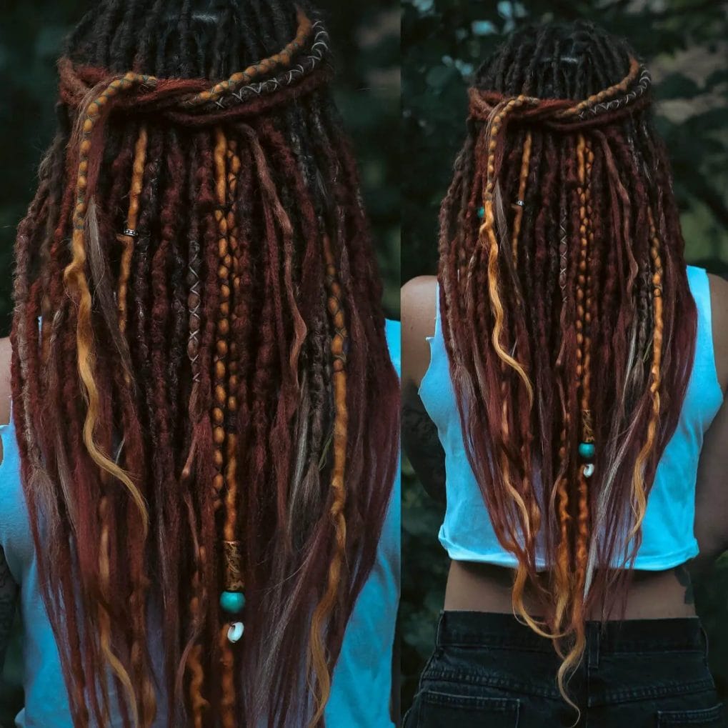 Brunette dreadlocks with dark red accents, decorated with threads and beads, and stylishly pulled back.