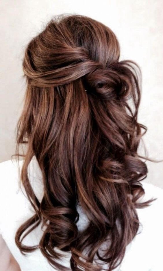 Half-up hairstyle with soft, cascading curls in rich brown, featuring a twisted upper section and flowing lower layers. Ideal for formal events.