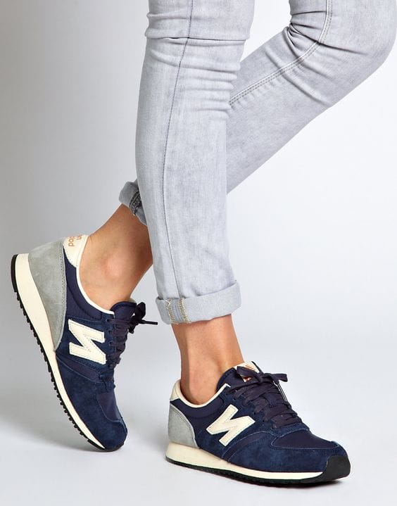 Navy suede sneakers with light grey accents and white logo, featuring a cushioned sole for casual wear and grip. Perfect for urban style.