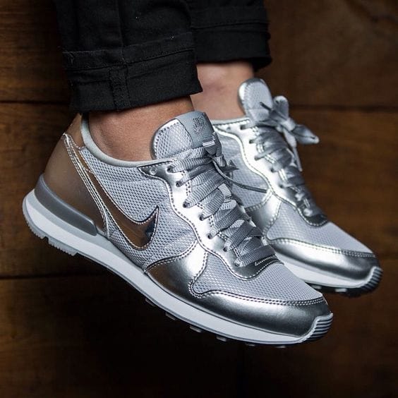 Sleek silver and metallic sneaker shoes for women, featuring breathable mesh, rubber outsole for grip, and padded collar for support.