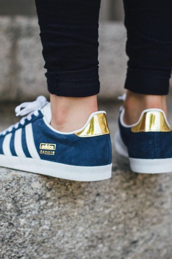 Navy suede sneakers with three white stripes and a gold-accented heel tab. Rounded toe and white rubber sole, perfect for urban casual wear.