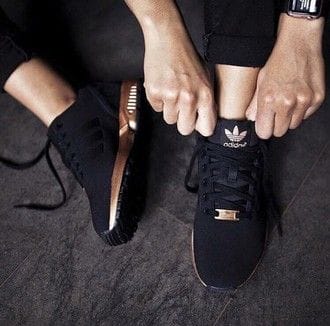 Black fabric sneaker shoes for women with sleek lines, lightweight feel, and bronze accents, perfect for casual wear and urban climates.