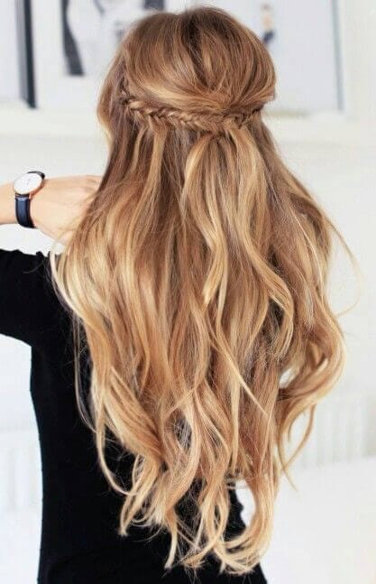 Cascading golden blonde waves with a fishtail braid at the crown, blending into loose curls. Perfect for special occasions.