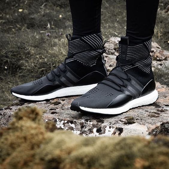 Sleek black high-top sneakers for women with breathable mesh, synthetic overlays, and lightweight foam sole for optimal cushioning.