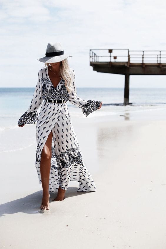 Wide-brimmed straw hat complements a beach dress, providing sun protection and stylish flair for warm climates. Perfect for summer outings.