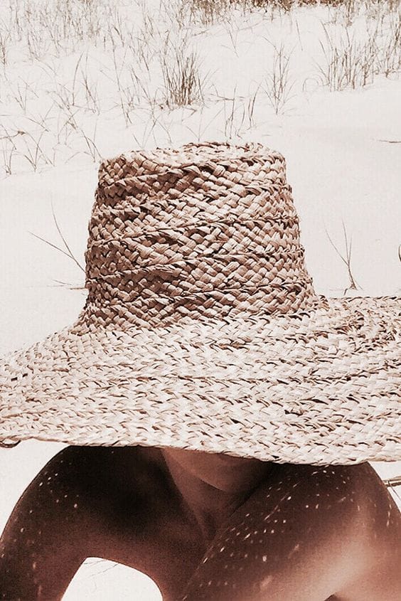 Wide-brimmed straw hat with a natural woven design, 12-inch brim, 6-inch crown, perfect for sun protection at the beach.