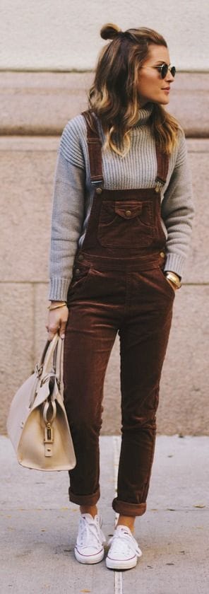 Brown corduroy overalls paired with a fitted gray sweater and white sneakers, creating a stylish, comfortable look for casual wear.