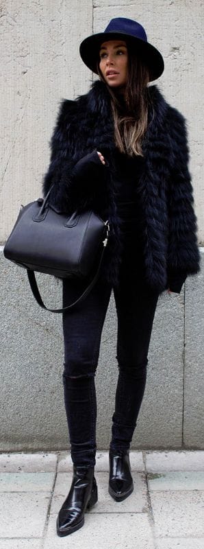 Sleek, straight hairstyle with subtle waves, paired with a stylish black fur coat and wide-brimmed hat, perfect for winter chic.