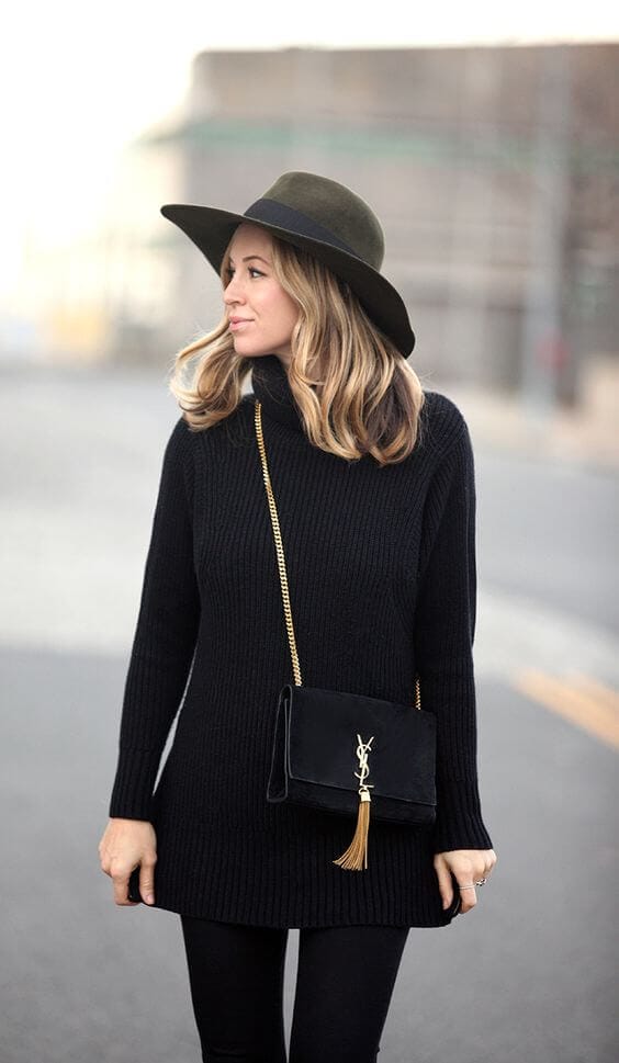 Soft, wavy hairstyle framing the face, paired with a black oversized knit sweater and skinny pants, ideal for winter hats styling.