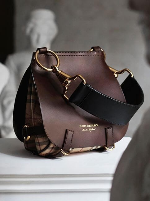 Structured brown leather handbag, 10x12 inches, dual strap design, gold-tone hardware, check-patterned lining. Versatile for casual and formal use.