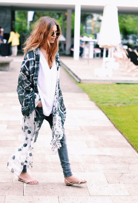 Casual summer outfit featuring a white blouse under a patterned kimono, paired with stylish sandals, perfect for warm weather.
