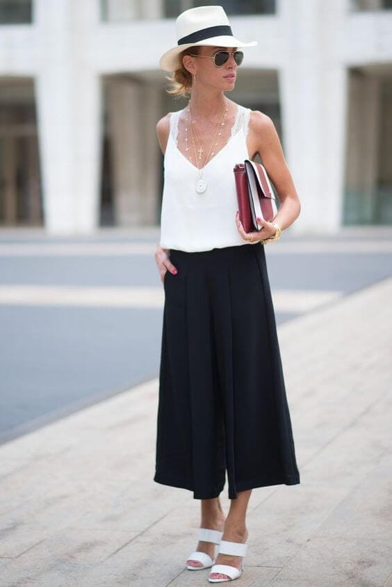 Sleek low ponytail complements an elegant black and white skirt outfit, exuding a sophisticated vibe perfect for office core aesthetics.