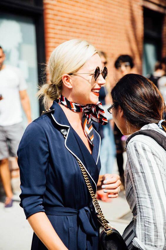 Sleek, polished bob hairstyle in light blonde, paired with a chic summer scarf, perfect for a sophisticated outfit.