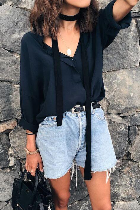 Relaxed summer scarf style with a deep navy hue, paired with a loose long-sleeved top and light denim shorts. Accented with a black choker.