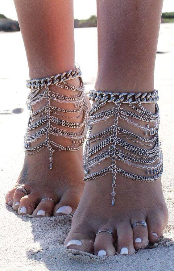 Delicate boho anklet featuring multiple silver chains with decorative charms, perfect for summer outings and beachwear.
