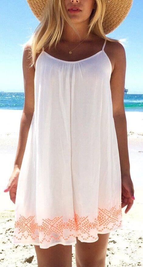 Flowy white sundress with delicate straps and coral embroidery, perfect for summer outings and casual gatherings.