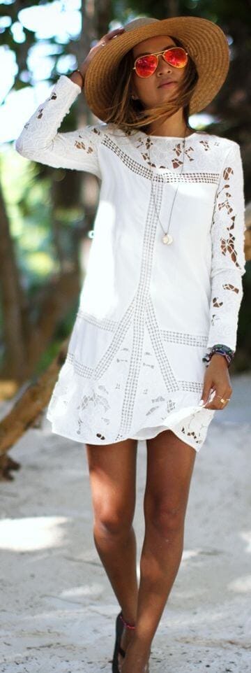 Flowy white sundress with loose, wavy layers, perfect for summer beach outings. Sun-kissed highlights enhance its casual elegance.