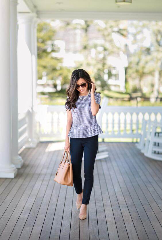 Soft, loose waves cascade down to the shoulders, paired with a peplum top and fitted trousers, embodying summer business casual elegance.