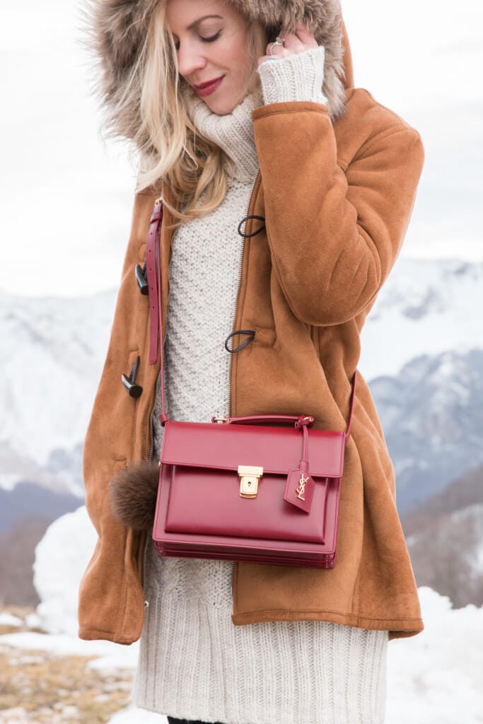 Chic winter outfit featuring an olive green parka jacket paired with an oversized knit sweater, perfect for cold weather outings.