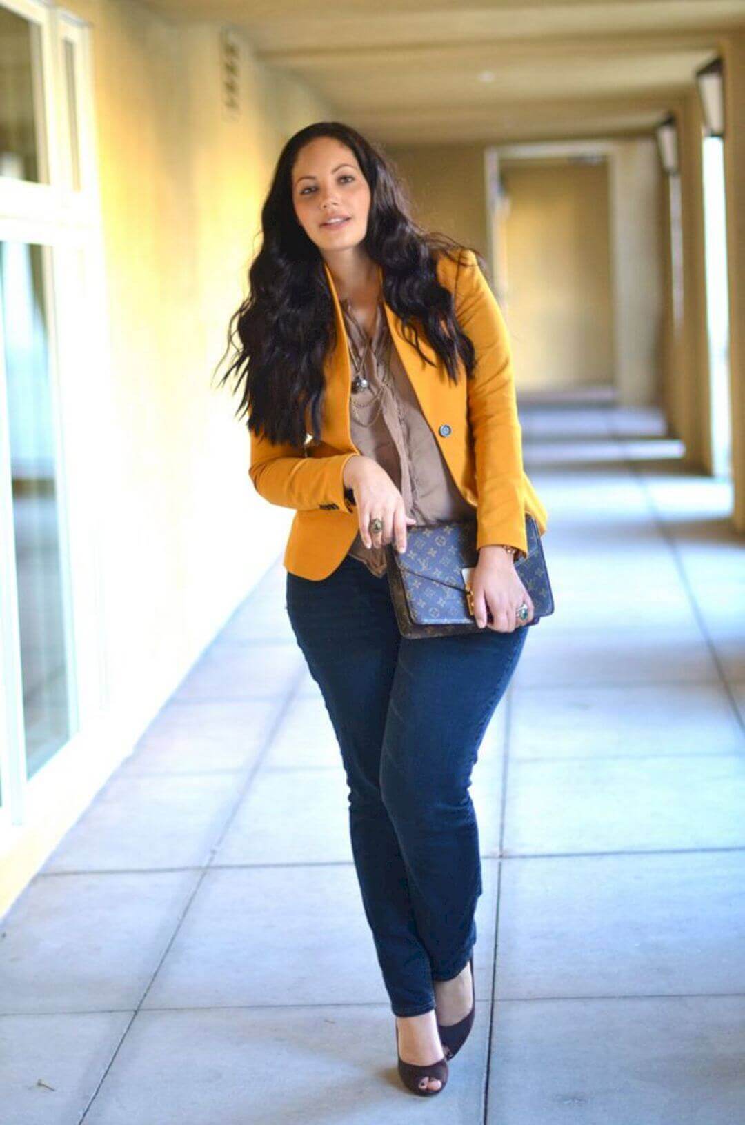 Plus size woman in a chic, monochrome office outfit, showcasing stylish business casual attire ideal for work settings.