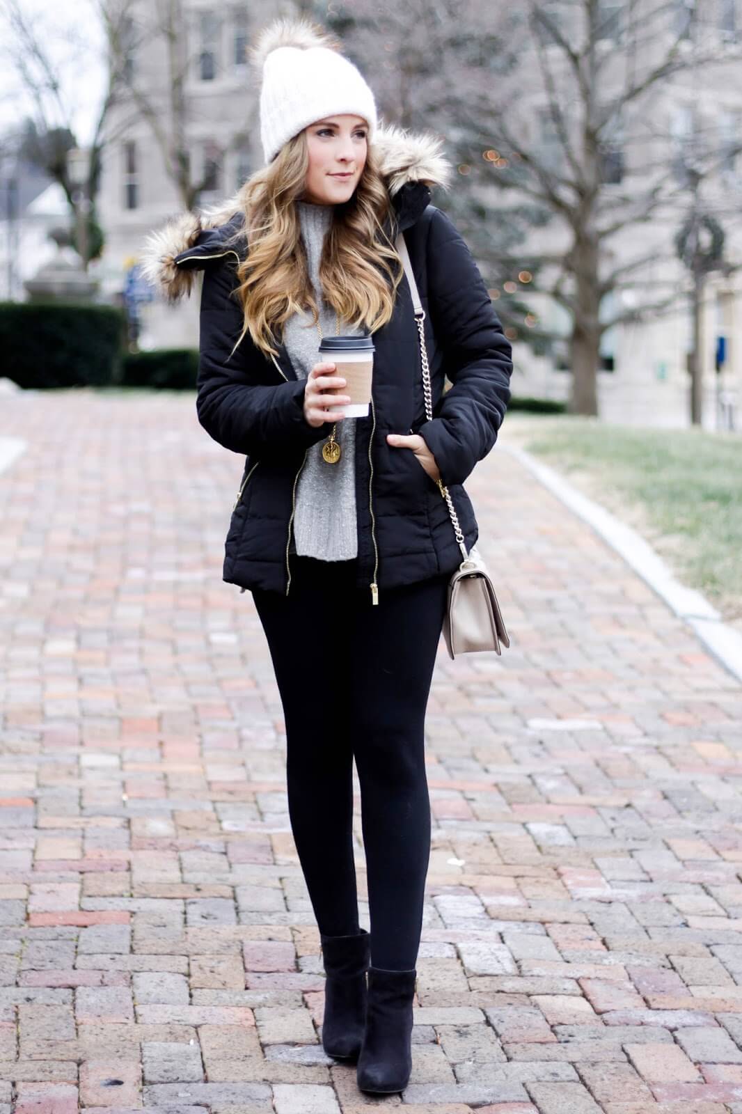 Chic winter outfit featuring a green parka jacket, cozy hat, and boots, set in a soft-lit outdoor scene with snow.