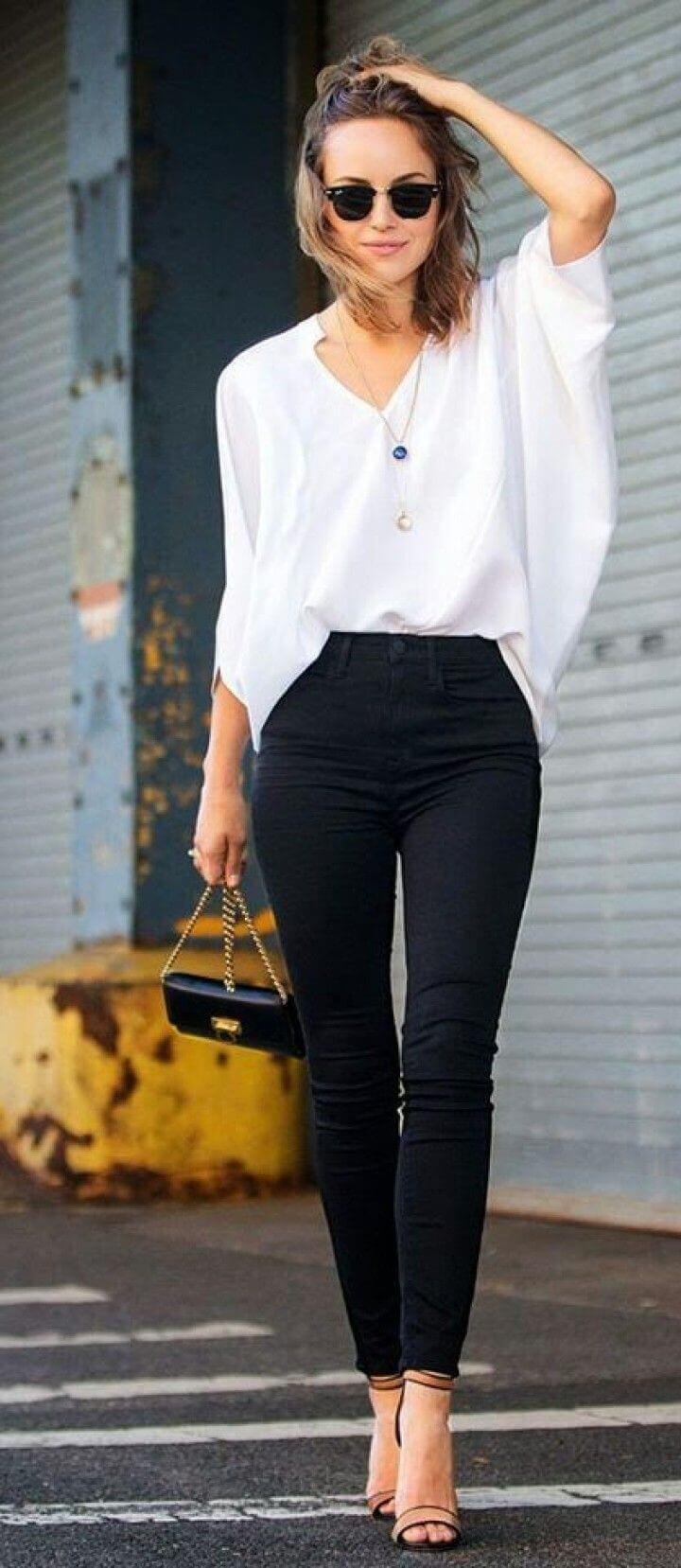 Casual office attire featuring a cream sweater and olive pants, paired with a chic hairstyle that enhances the overall stylish look.