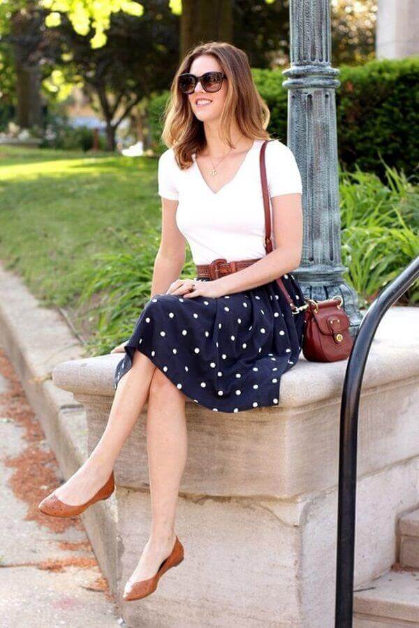 Casual office attire featuring a cream sweater, stylish olive pants, and a casual blazer, perfect for a polished yet relaxed look.
