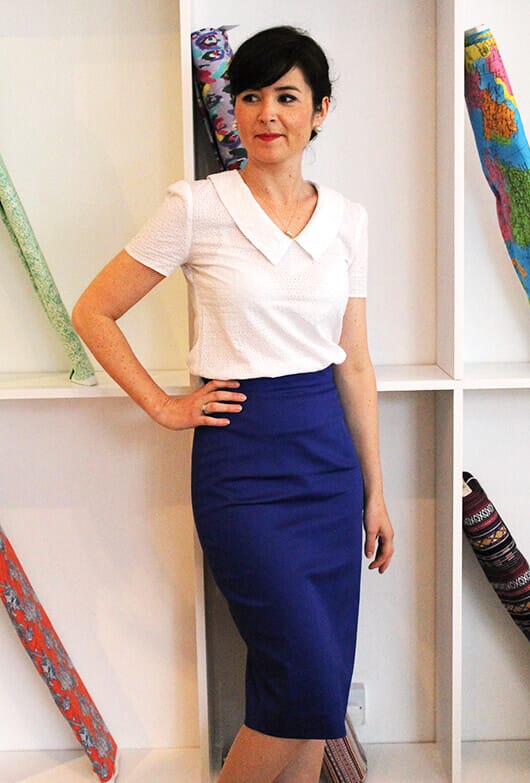 Fitted blue dress paired with a white short-sleeve blouse featuring a Peter Pan collar, ideal for pencil skirt outfits.