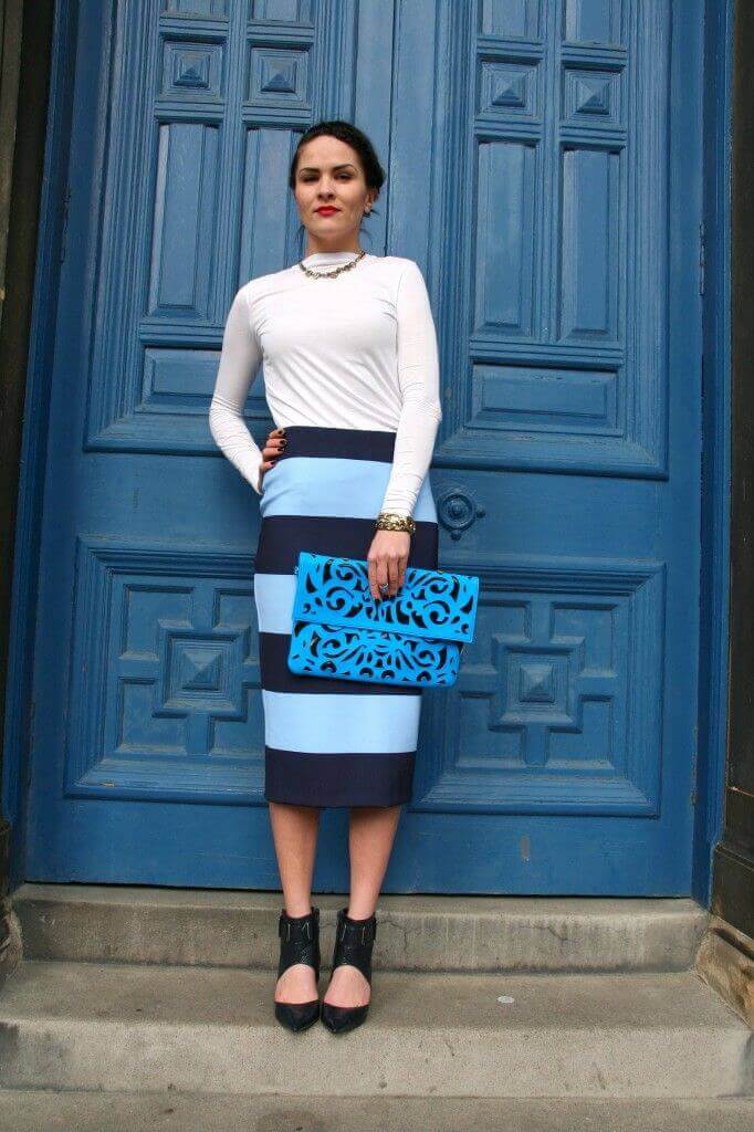 Sleek bob hairstyle complements a fitted top and color-blocked pencil skirt, enhancing elegance for work or casual outfits.