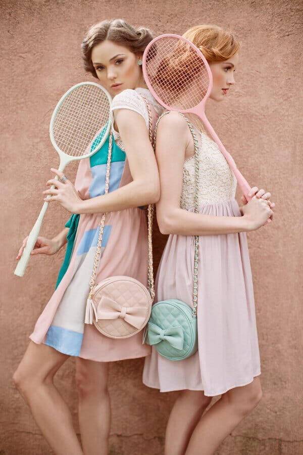 Two models showcase pastel outfits with quilted crossbody bags—one pink, one mint green—against a warm-toned wall, embodying soft girl aesthetic.