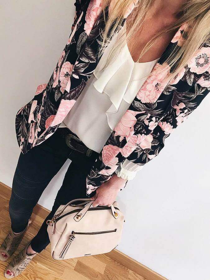 Floral blazer with vibrant pink and green patterns, paired with a white ruffled blouse and dark skinny jeans, exudes soft girl aesthetic.