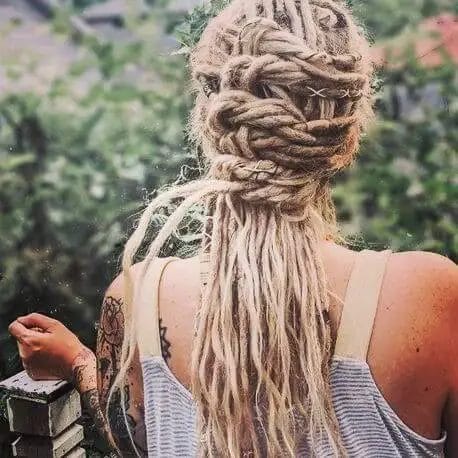 Halo crown made of blonde dreadlocks intertwined with decorative threads, with loose dreads draping below.