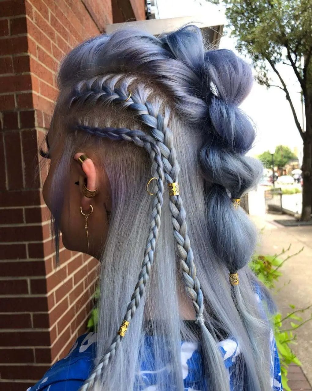 Ash-blue half-up hairstyle with mixed Viking braids and golden accessories.