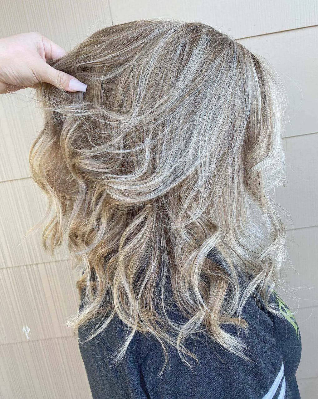 Beachy tousled waves with sun-kissed gray-blending highlights.