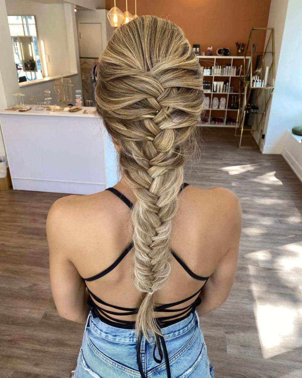Intricately woven French braid with a blonde gradient from ash to platinum.