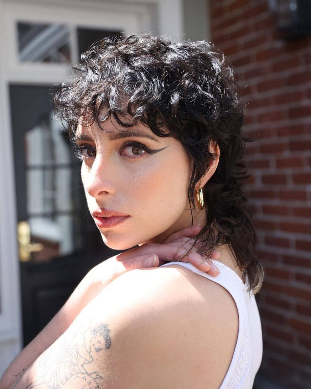 Bouncy curls with tousled finish and dark fringe.