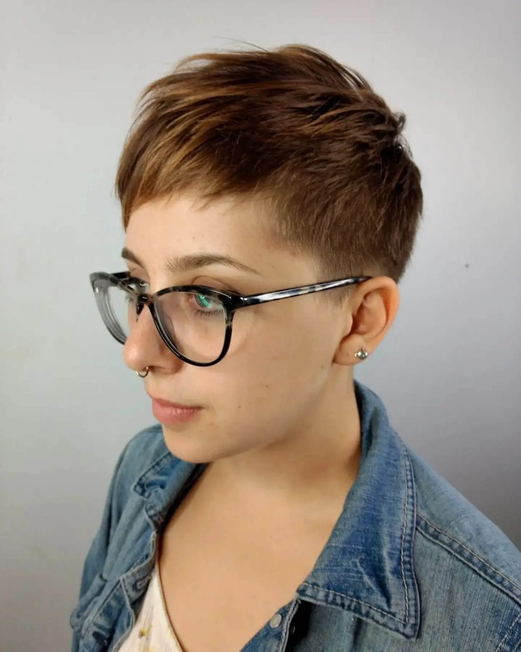 Chestnut brown pixie with textured layers and undercut.