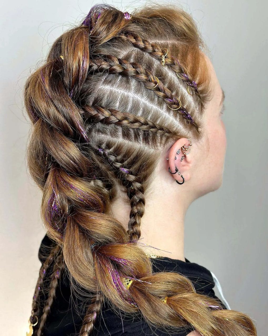 Chestnut and golden streaked Viking braids with purple tinsel highlights.