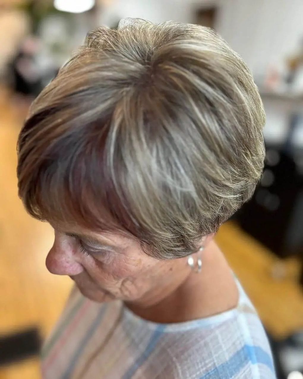 Natural brown and grey feathered pixie cut for a sophisticated look.