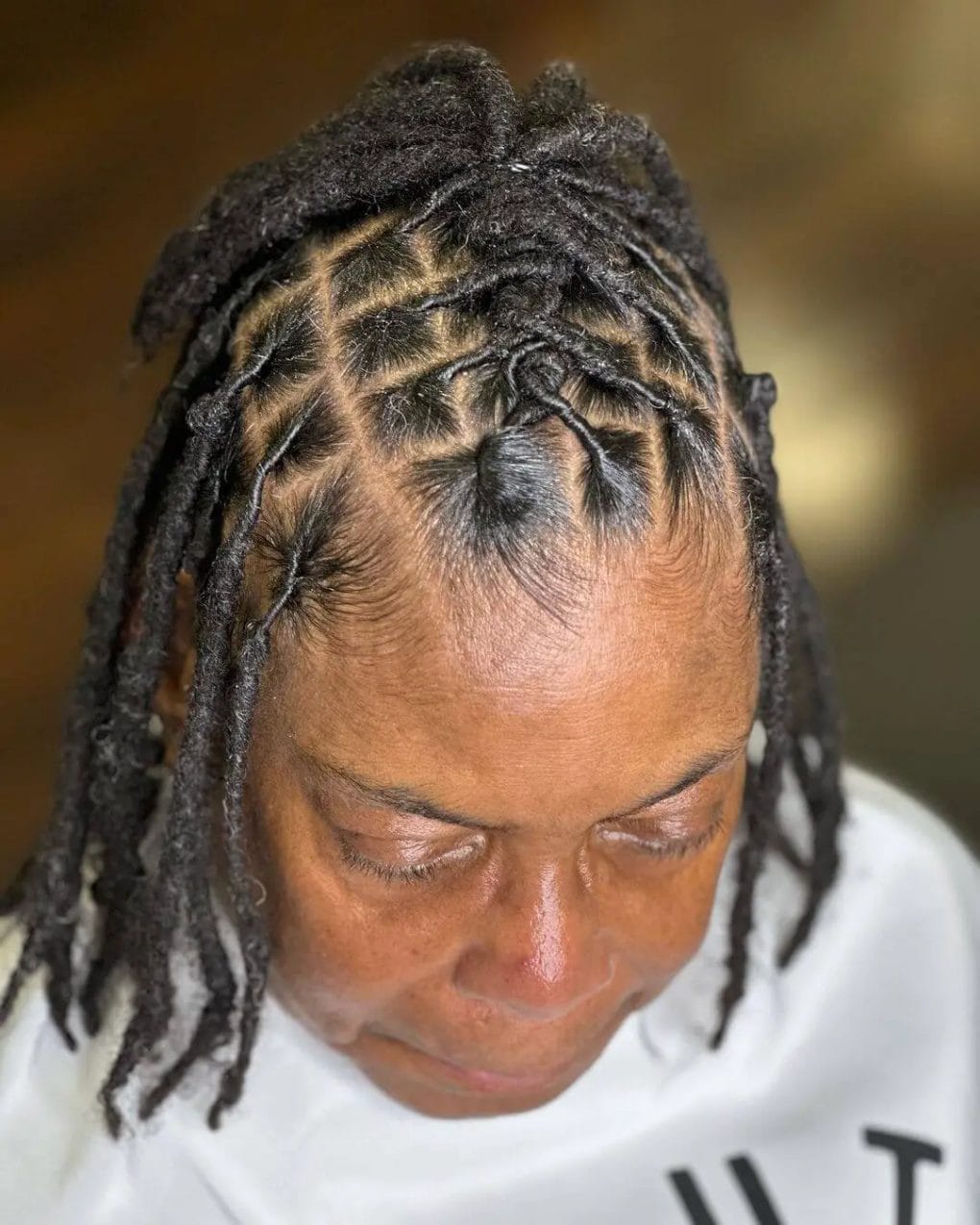 Natural black hair with a mix of cornrows and dreadlocks for cultural flair.