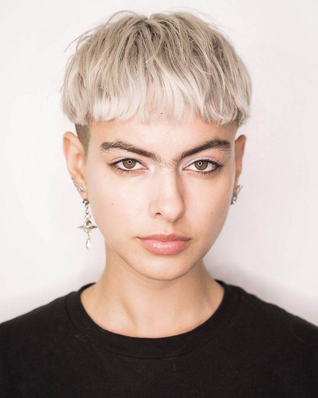 Edgy platinum pixie with straight-across fringe.