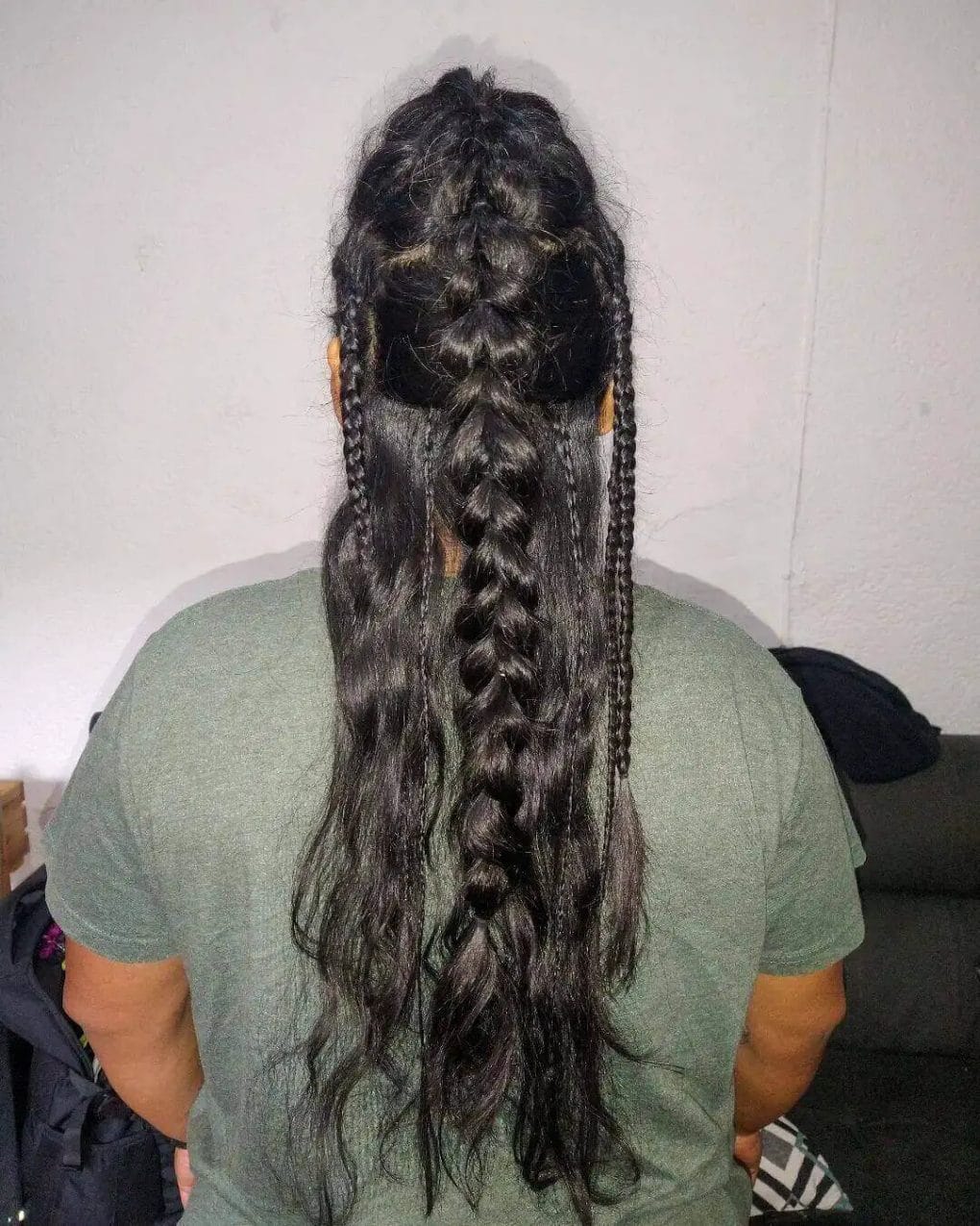 Dark-toned hair with a central Viking braid and symmetric side braids.