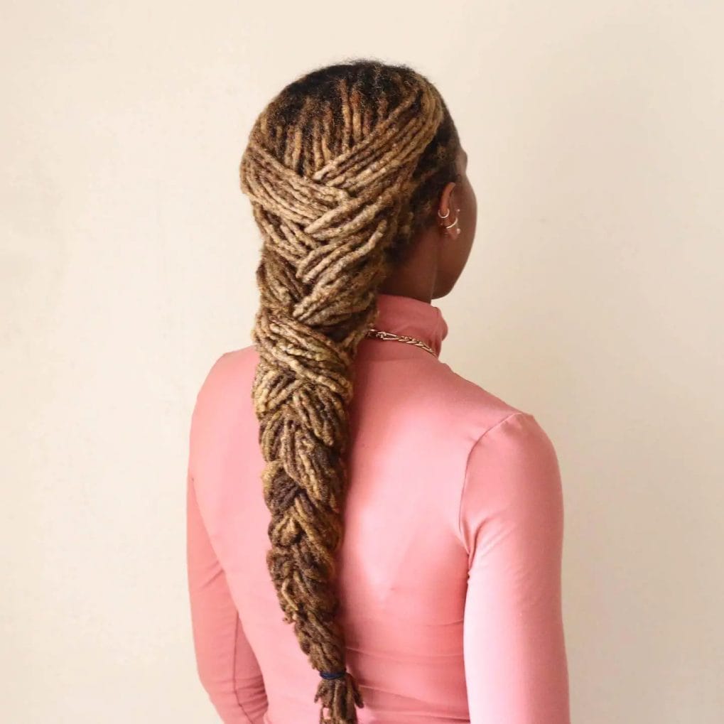 Unique French braid made with dreadlocks in rich brown and blonde tones.