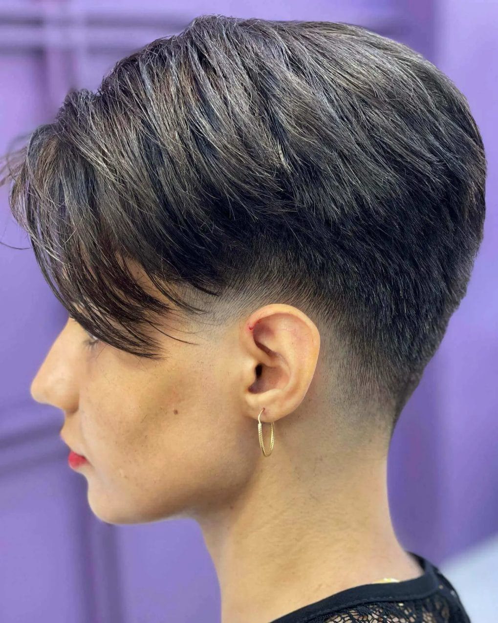 Side-parted brunette pixie with layered fringe.