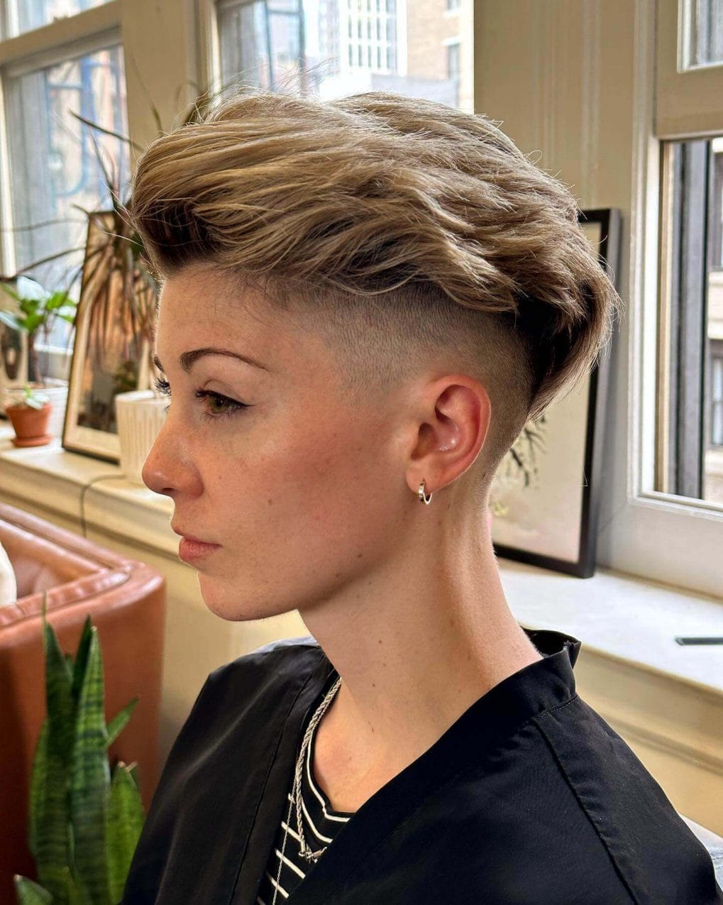 Sandy-highlighted brunette pixie with edgy undercut.