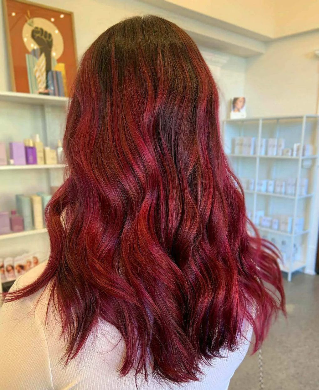 Brunette base to fiery red balayage in long, cascading layers.