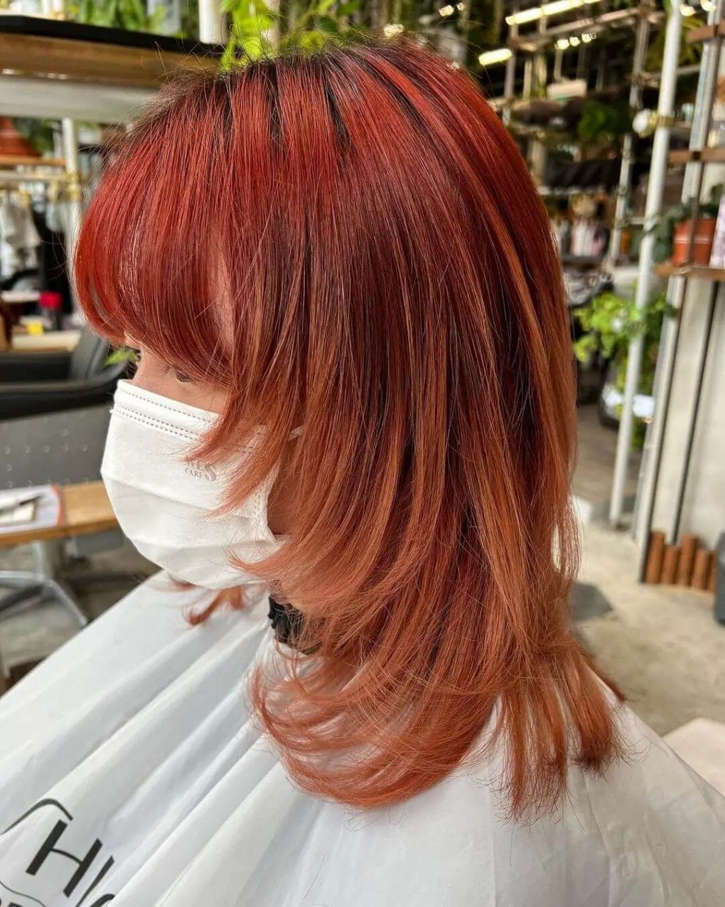 Bold fiery copper wolf cut with red streaks and precision layers.