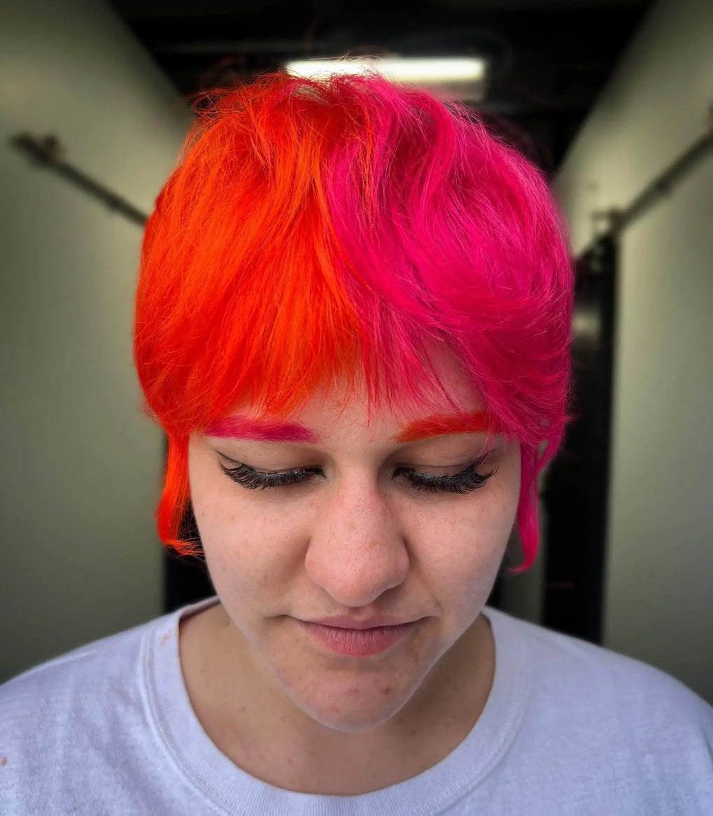 Fiery red to hot pink sunset effect in edgy pixie cut.