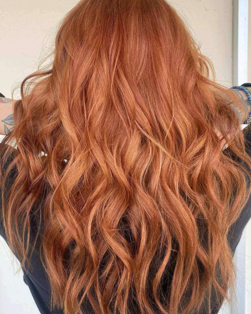 Long layers with blonde to red balayage resembling fiery waves.